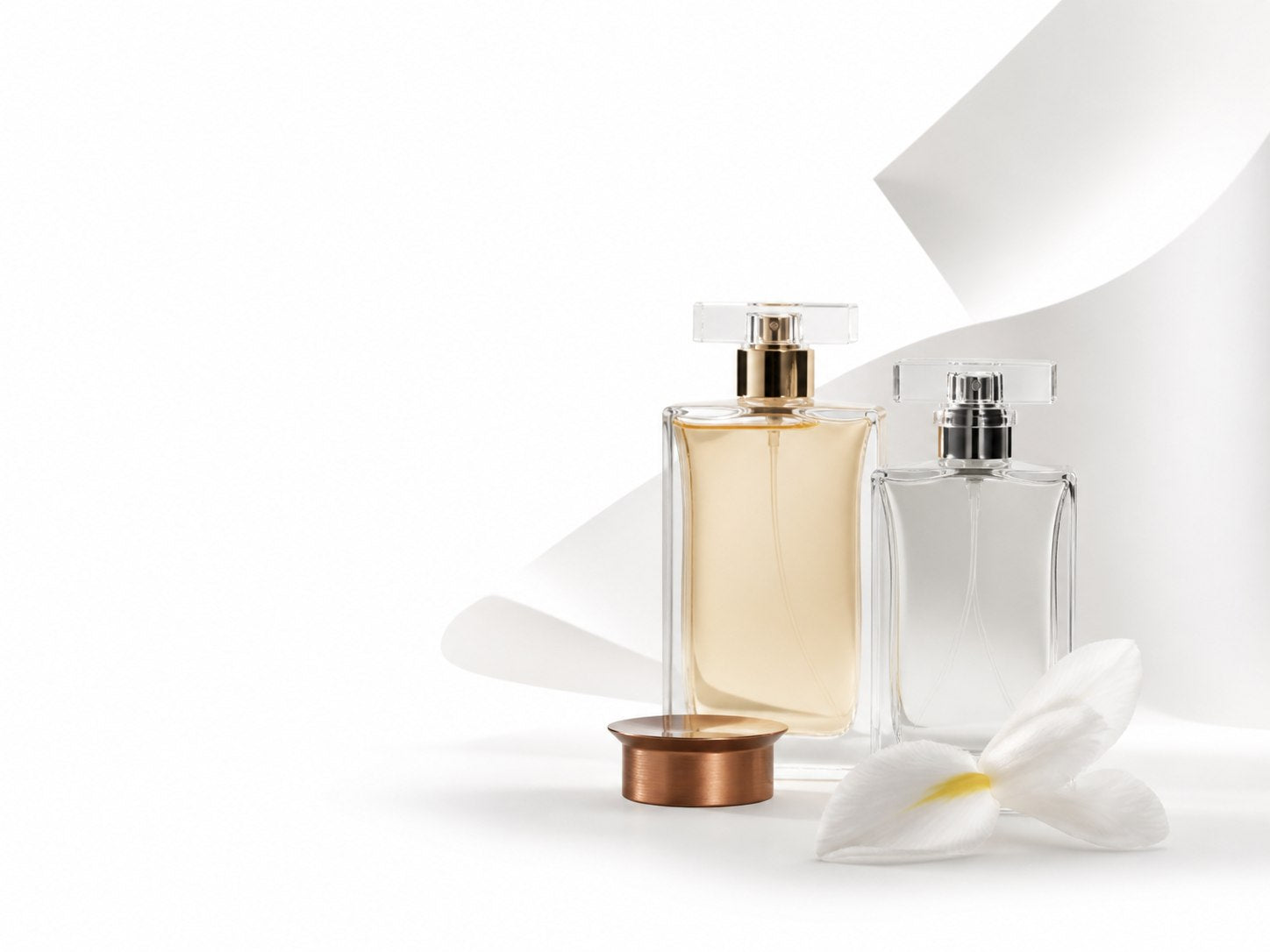 Editorial fragrance bottles on a white studio background
